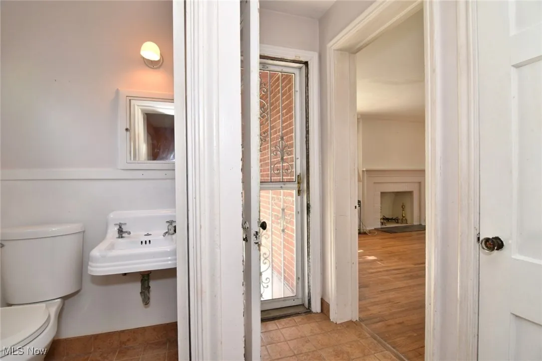 Half bathroom featuring toilet and a sink first floor