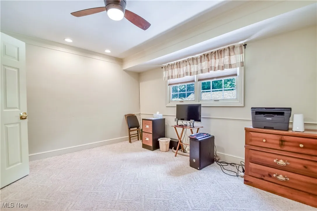 Carpeted office space featuring ceiling fan and recessed lighting