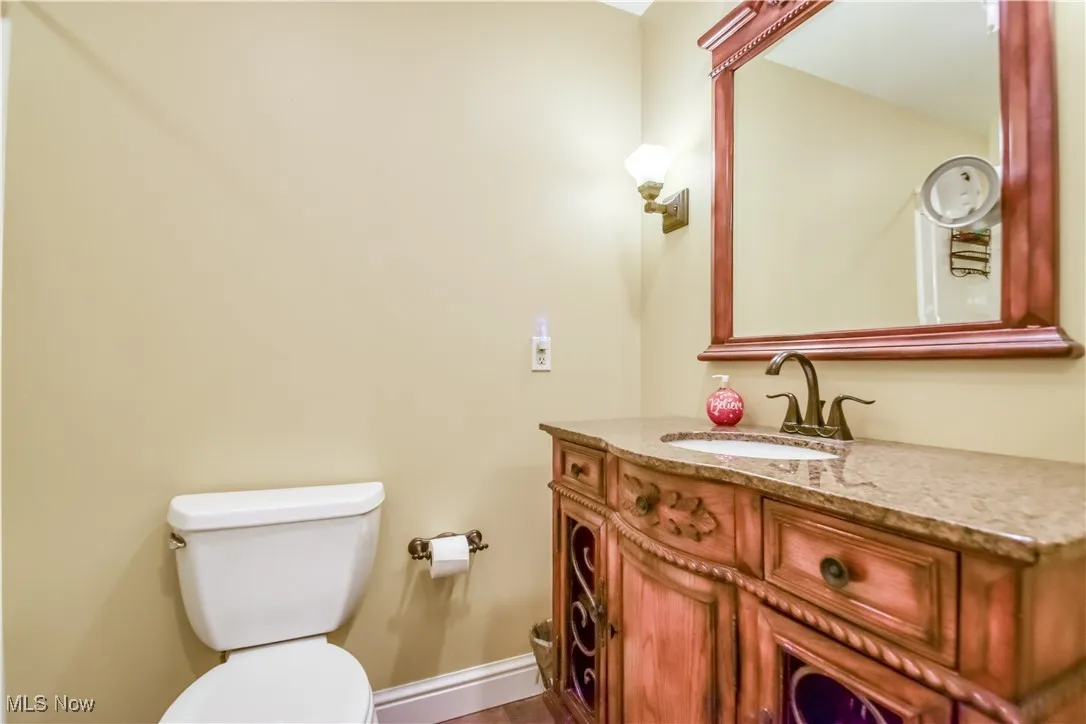Half bathroom with toilet and vanity