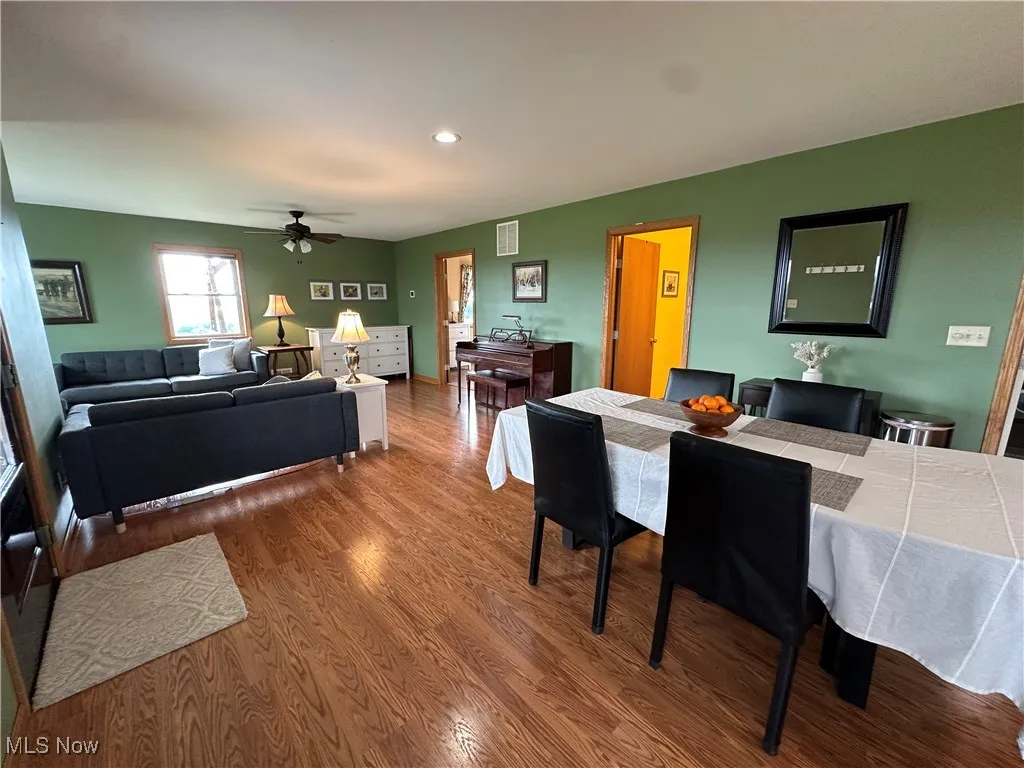 Dining room with a ceiling fan, recessed lighting, and wood finished floors