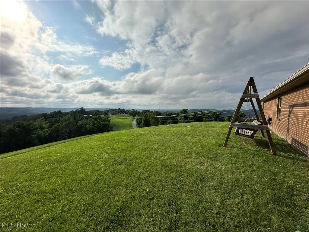 View of green lawn with a view of countryside