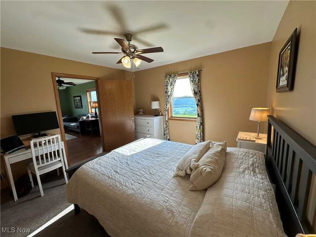 Bedroom featuring a desk and a ceiling fan