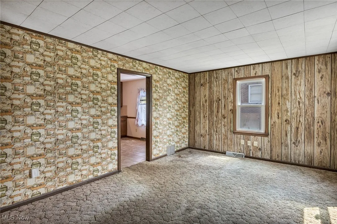 Spare room featuring carpet floors and ornamental molding