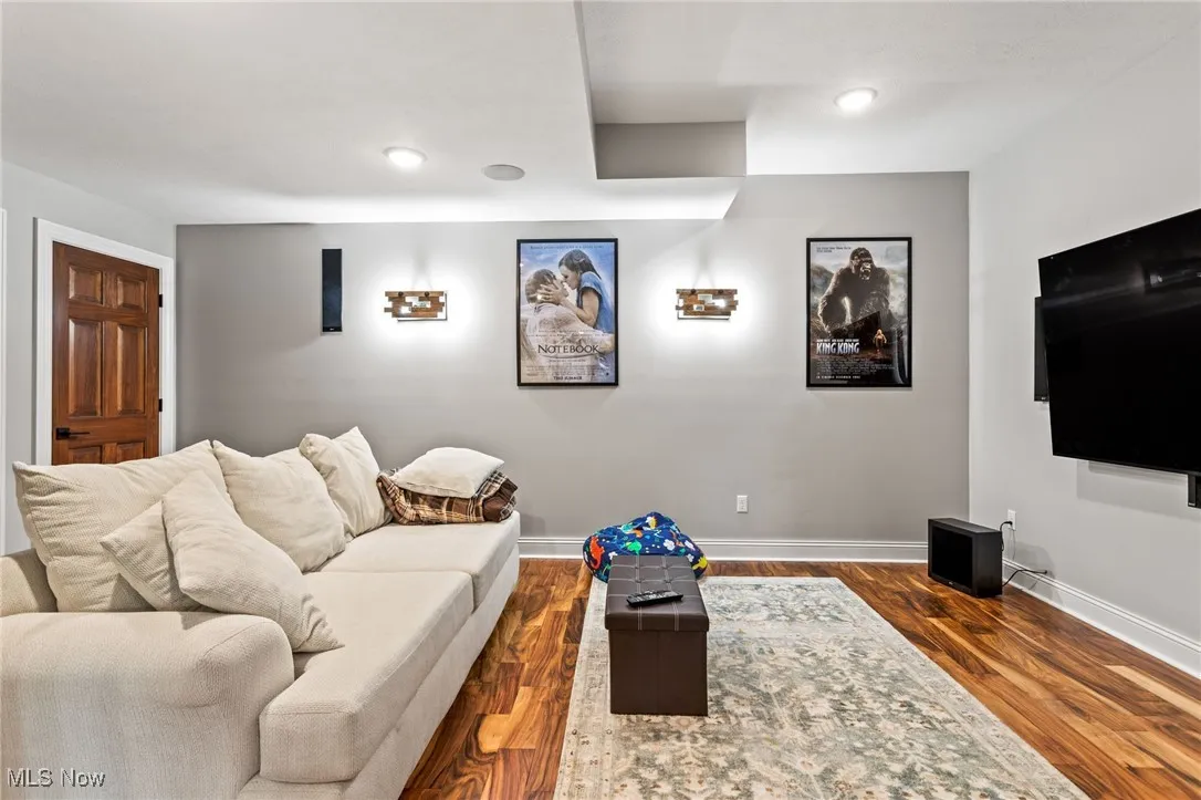 Living area featuring dark wood-style floors and recessed lighting