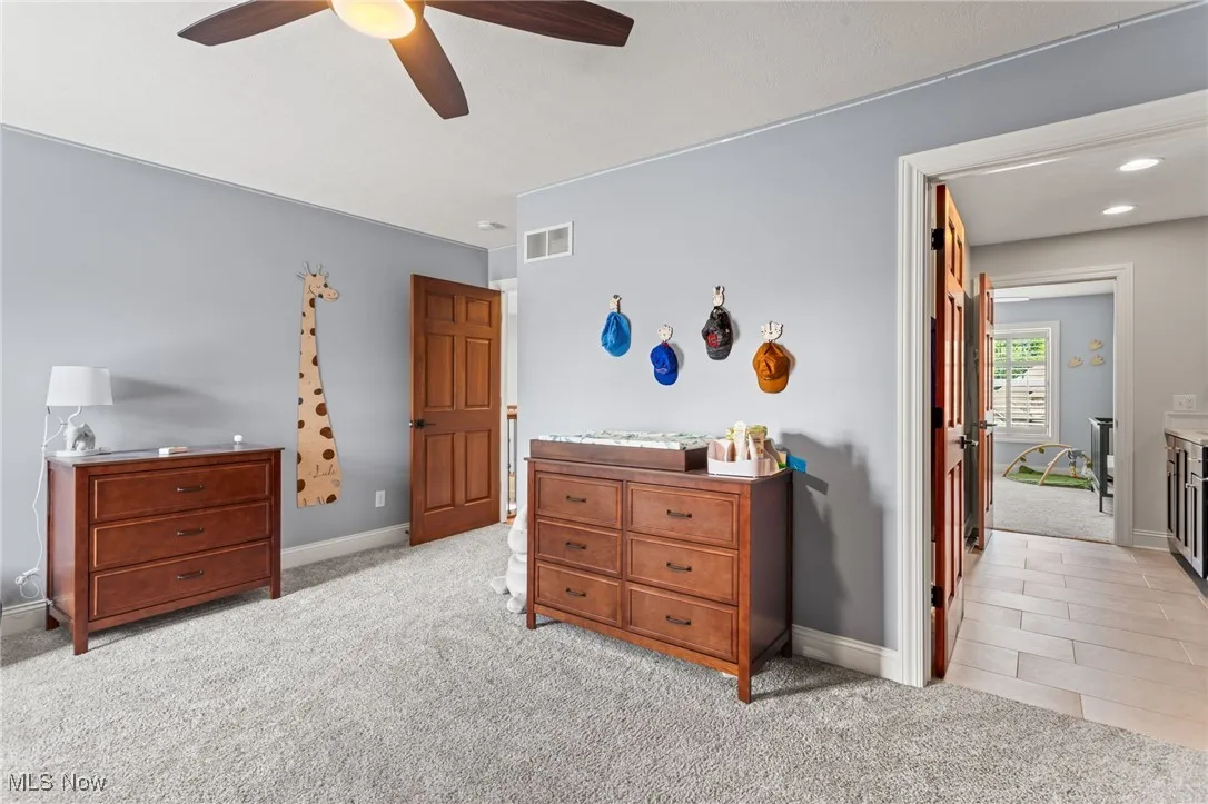 Bedroom featuring light carpet and a ceiling fan