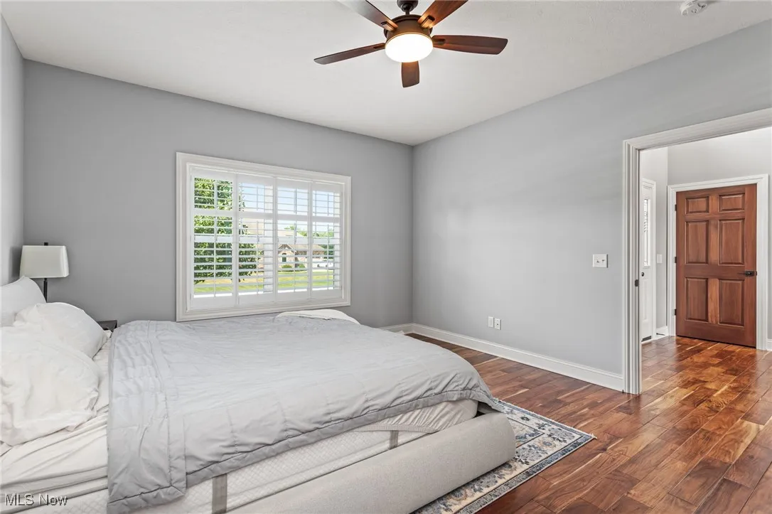 Bedroom featuring dark wood-style floors and ceiling fan