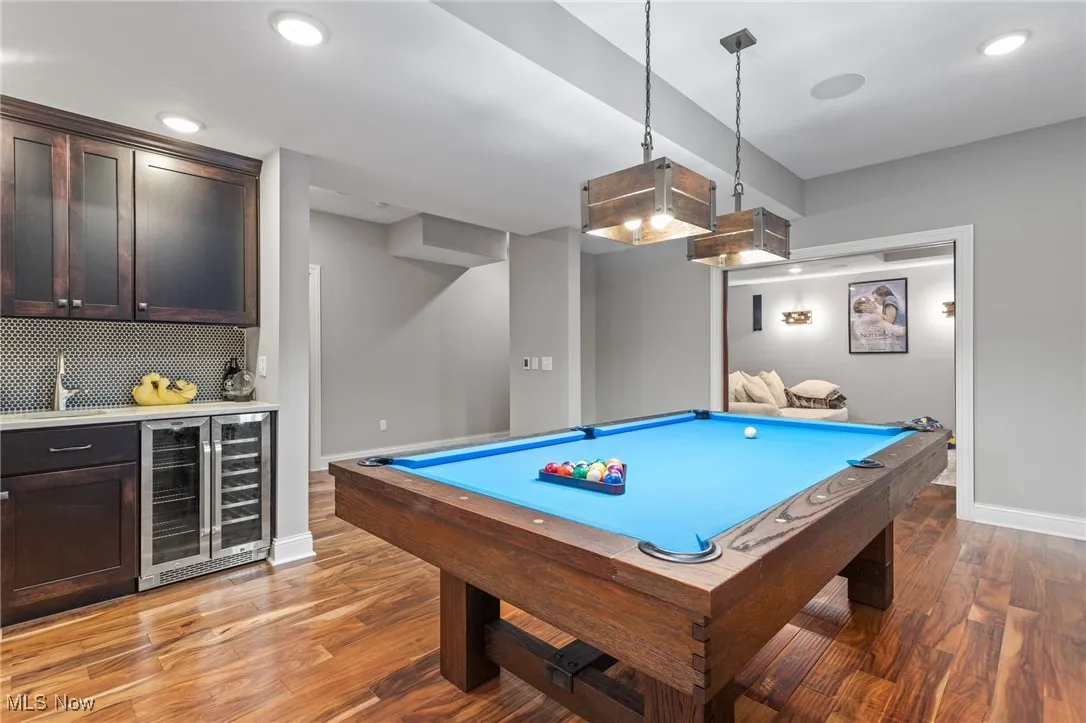 Recreation room with wet bar, beverage cooler, light wood-type flooring, pool table, and recessed lighting