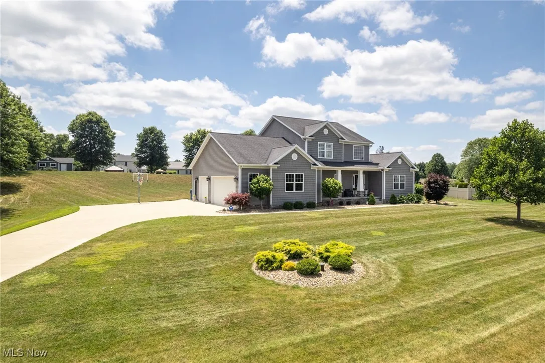 Craftsman inspired home with concrete driveway, a front yard, a garage, and a porch