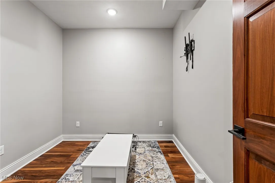 Unfurnished room featuring dark wood-type flooring and recessed lighting