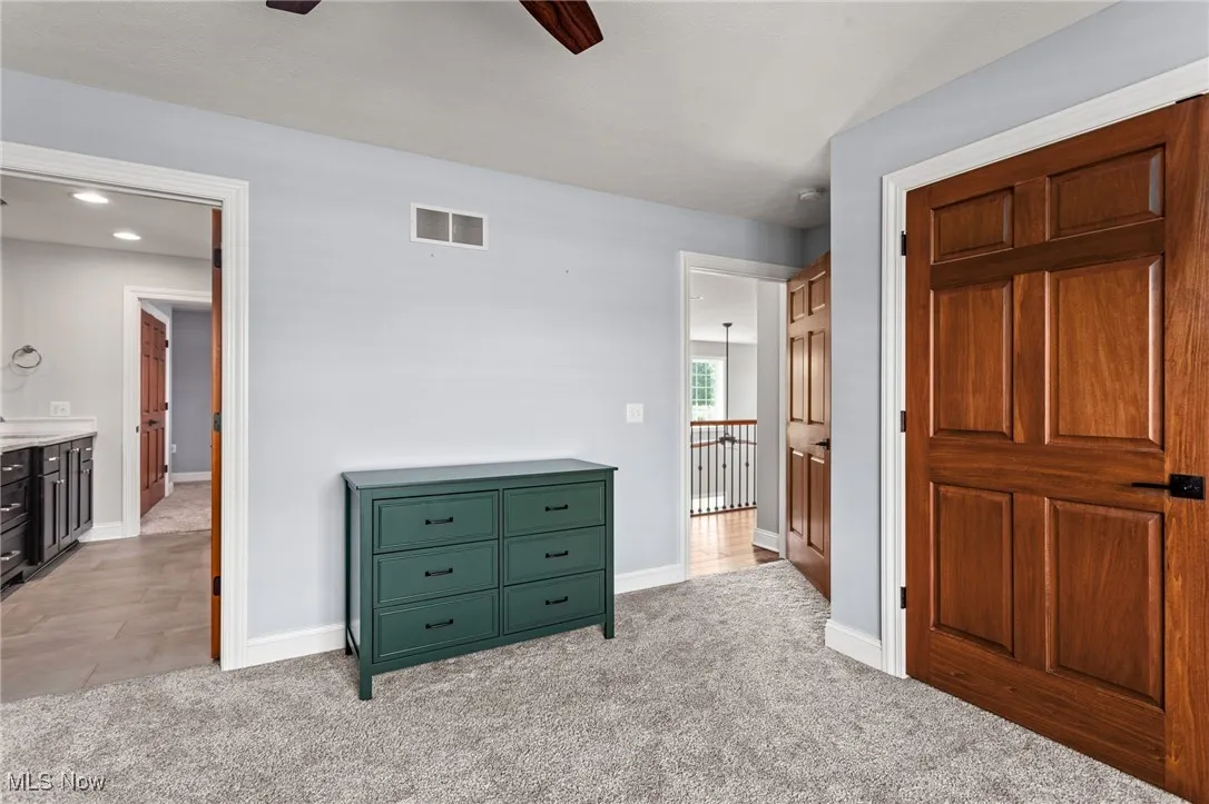 Unfurnished bedroom with light carpet, a ceiling fan, and recessed lighting