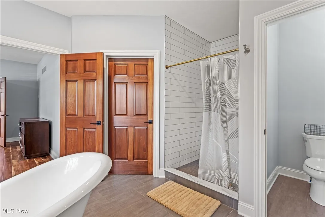 Bathroom featuring a stall shower and a freestanding bath