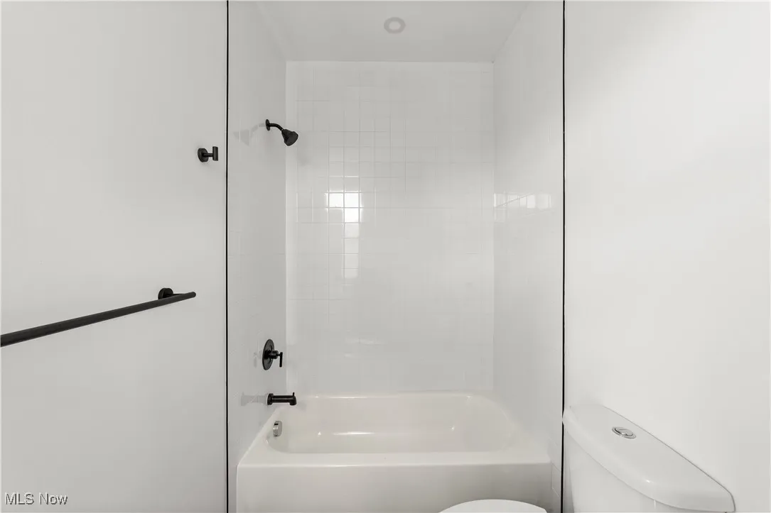 Full bath featuring toilet and shower / bath combination