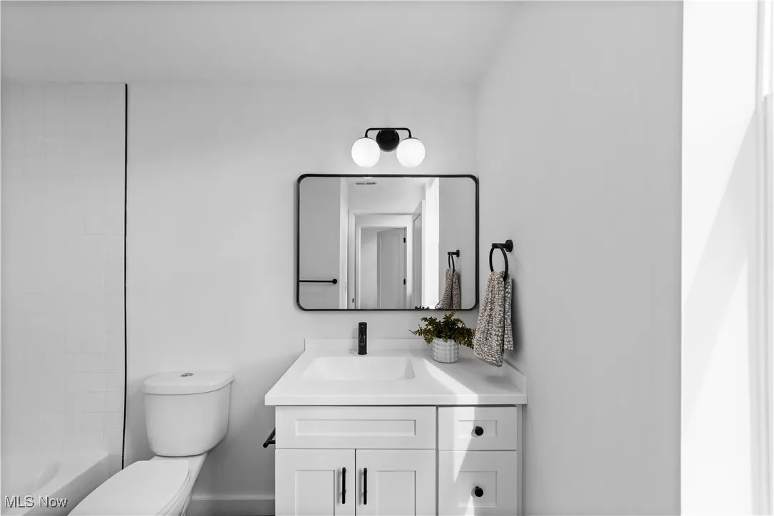 Bathroom with vanity and shower / washtub combination