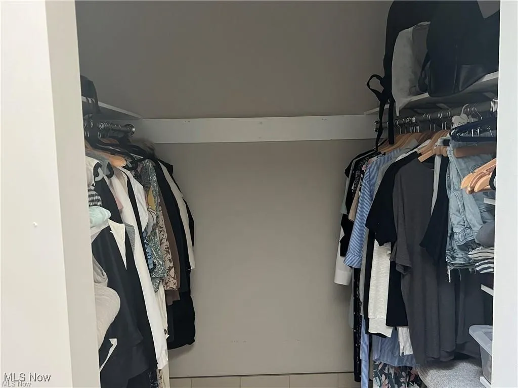 Walk in closet with tile patterned floors