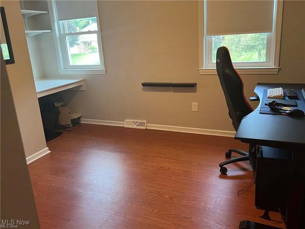 Office with wood finished floors and plenty of natural light
