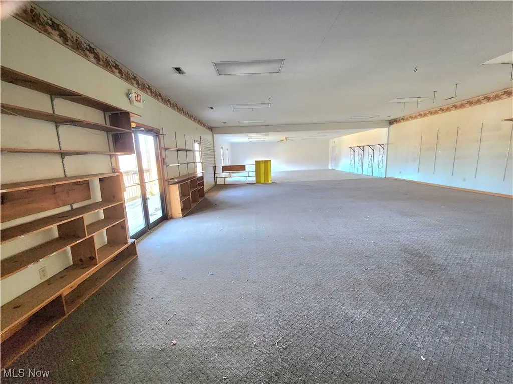 Carpeted empty room with french doors