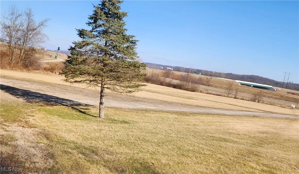 View of yard with a rural view
