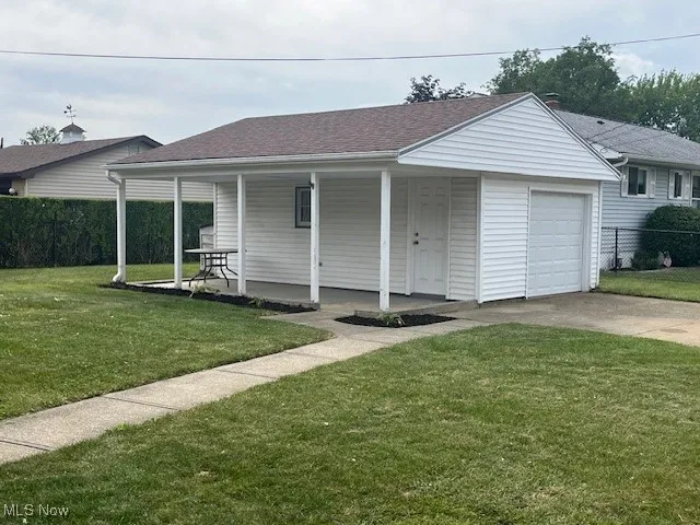Ranch-style house with a porch, concrete driveway, and roof with shingles