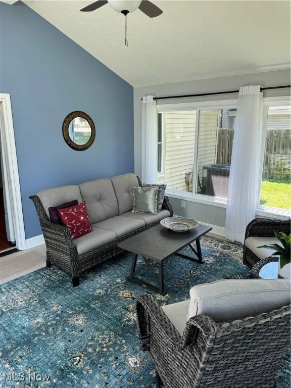 Sunroom / solarium featuring vaulted ceiling and healthy amount of natural light