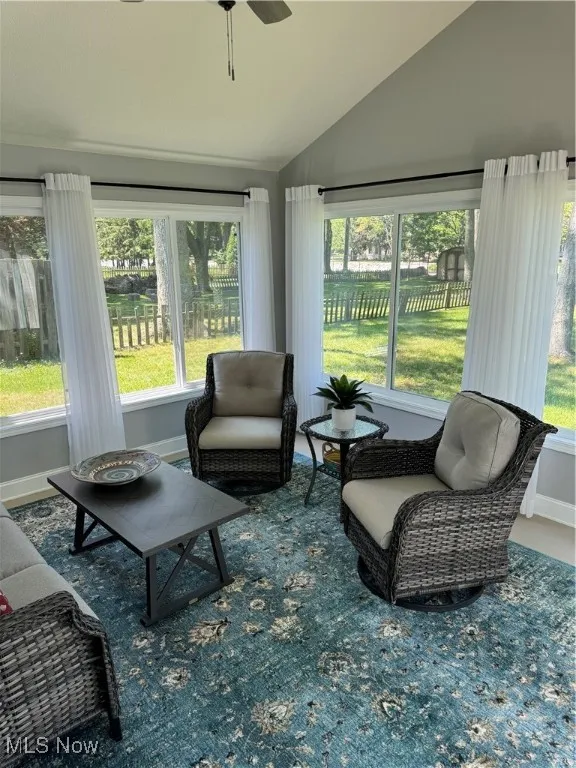Sunroom / solarium featuring vaulted ceiling and healthy amount of natural light