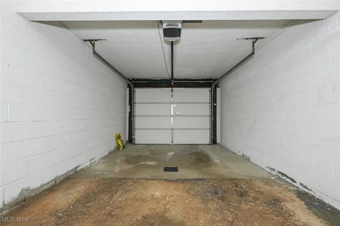 Garage with a garage door opener and concrete block wall