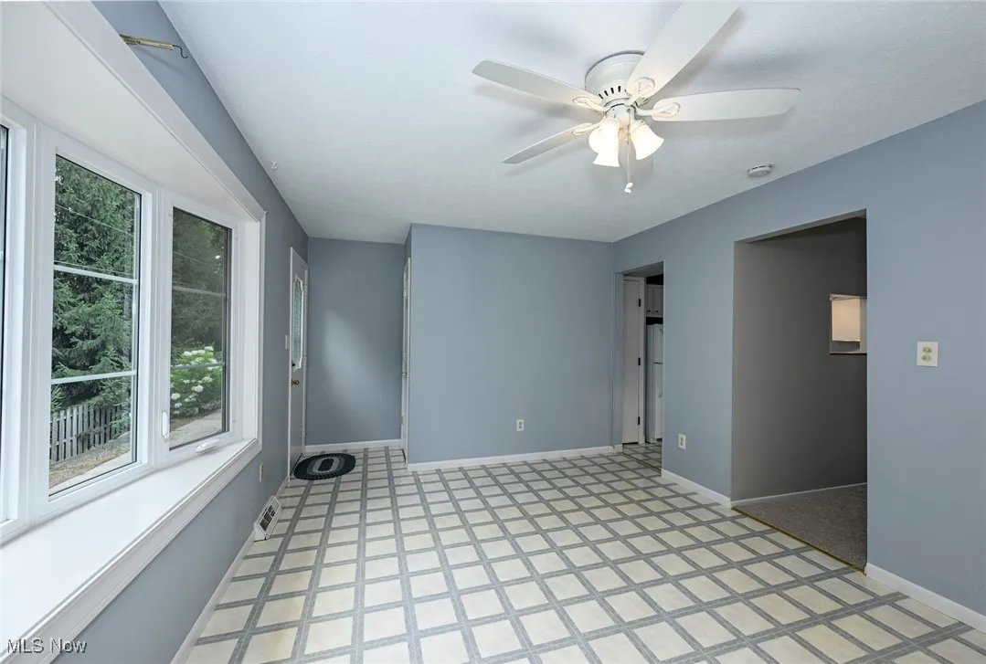 Spare room featuring light floors and ceiling fan