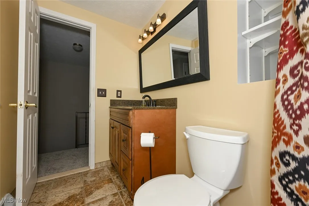 Bathroom with vanity and stone finish floors