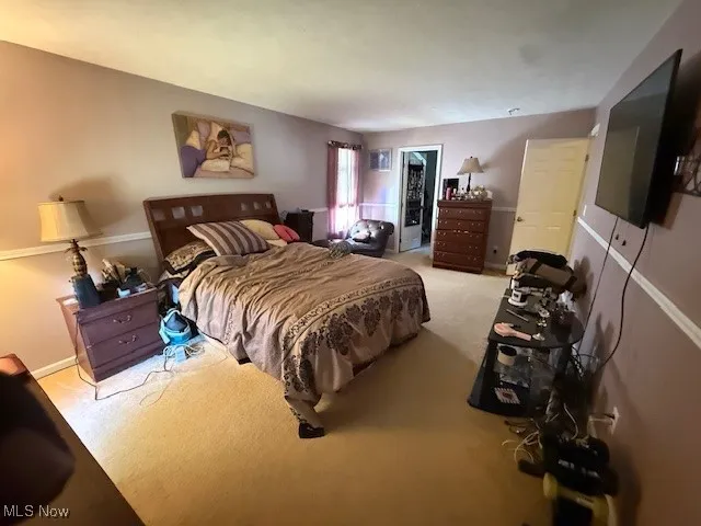 Carpeted bedroom with baseboards