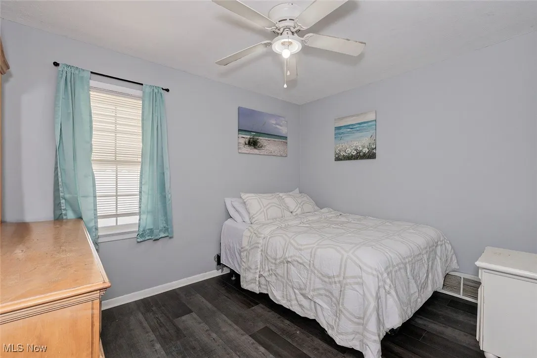One of 3 bedrooms on the main floor. Note there is a ceiling fan, and good wall space for furniture placement