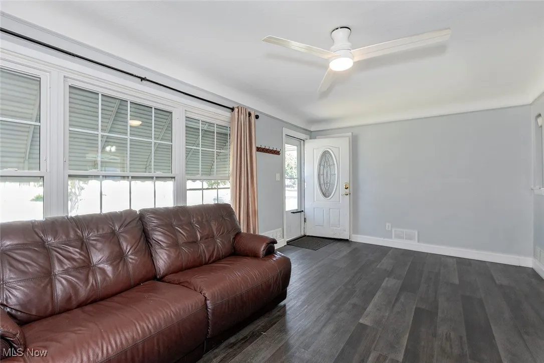 Large set of windows bring in natural light to the Living Room.