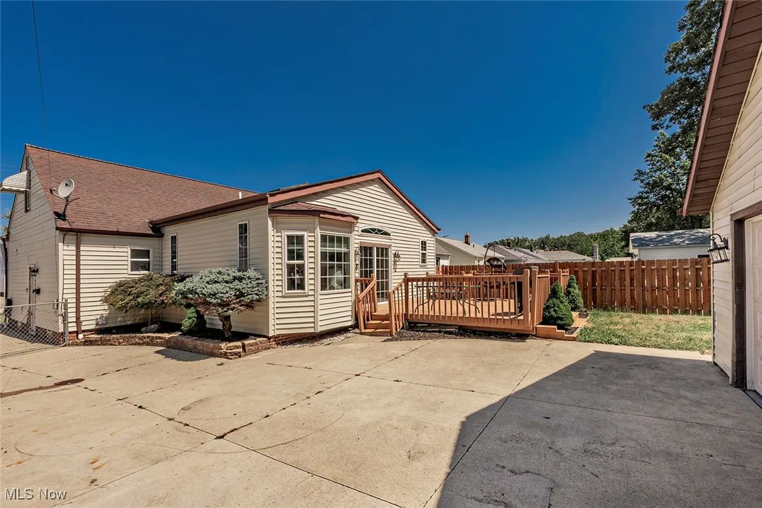 The back and side view of this home shows the bay window and back of the Family Room and deck.