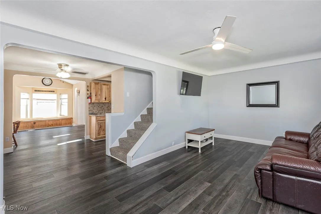 View of open floorplan shows the Living Room, Dinette and Family Room. There are ceiling fans in all 3 rooms, and vinyl plank flooring throughout the first floor.