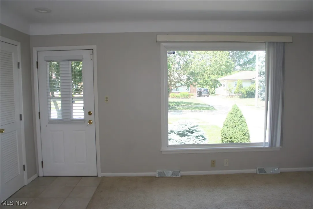 Foyer featuring healthy amount of natural light and light tile patterned floors