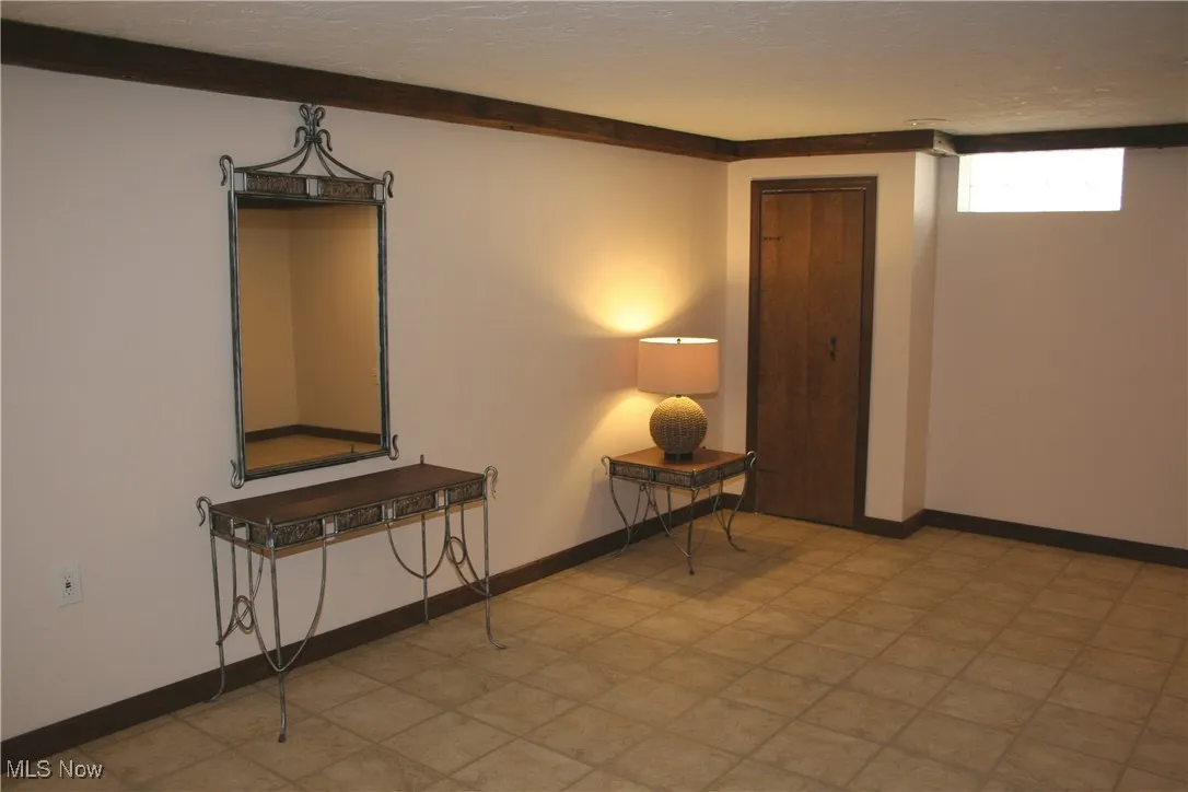 Spare room featuring light flooring and a textured ceiling