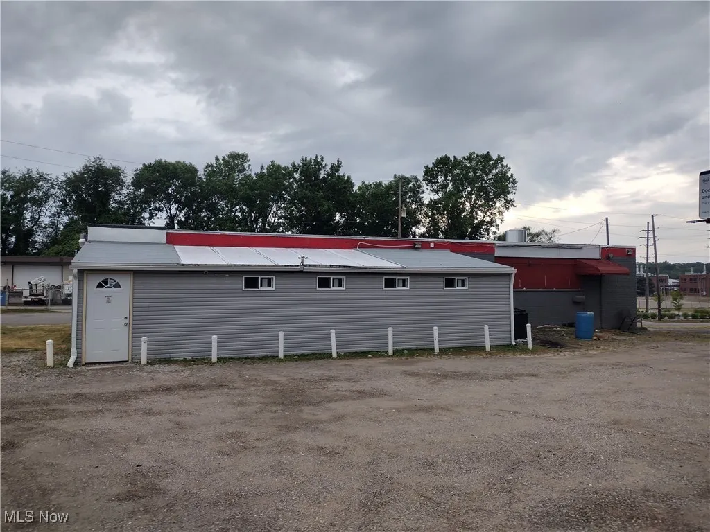 Rear view of property featuring a metal roof