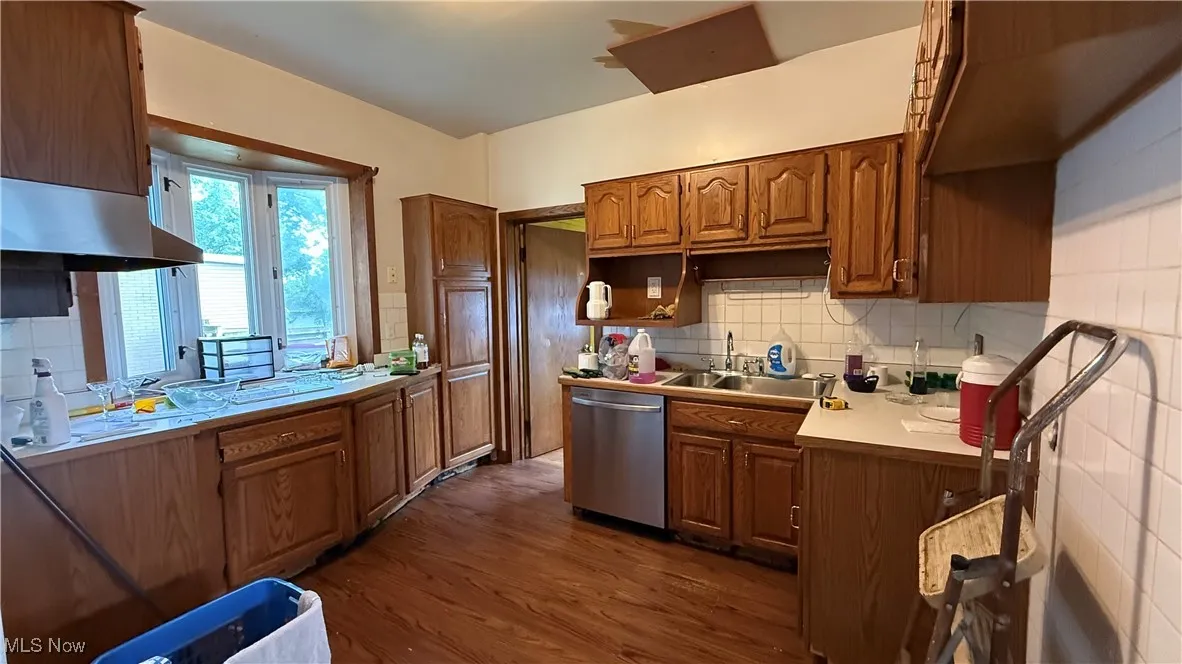 Kitchen with stainless steel dishwasher, and oak cabinets
