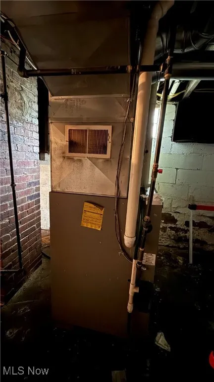 Utility room featuring heating unit