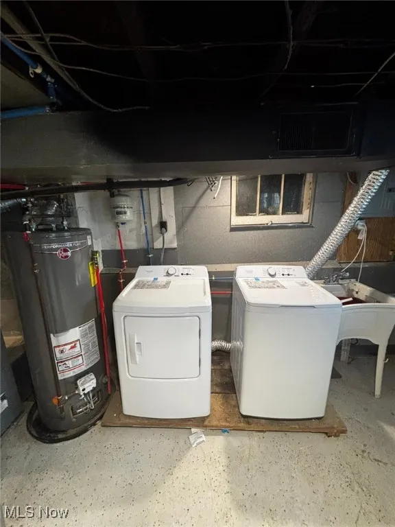Laundry area with washing machine and clothes dryer and gas water heater