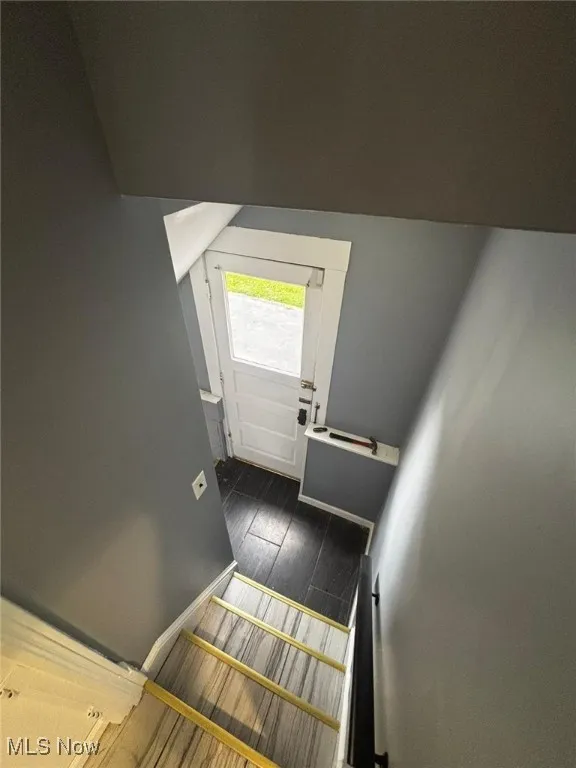 Entryway featuring baseboards and wood finished floors