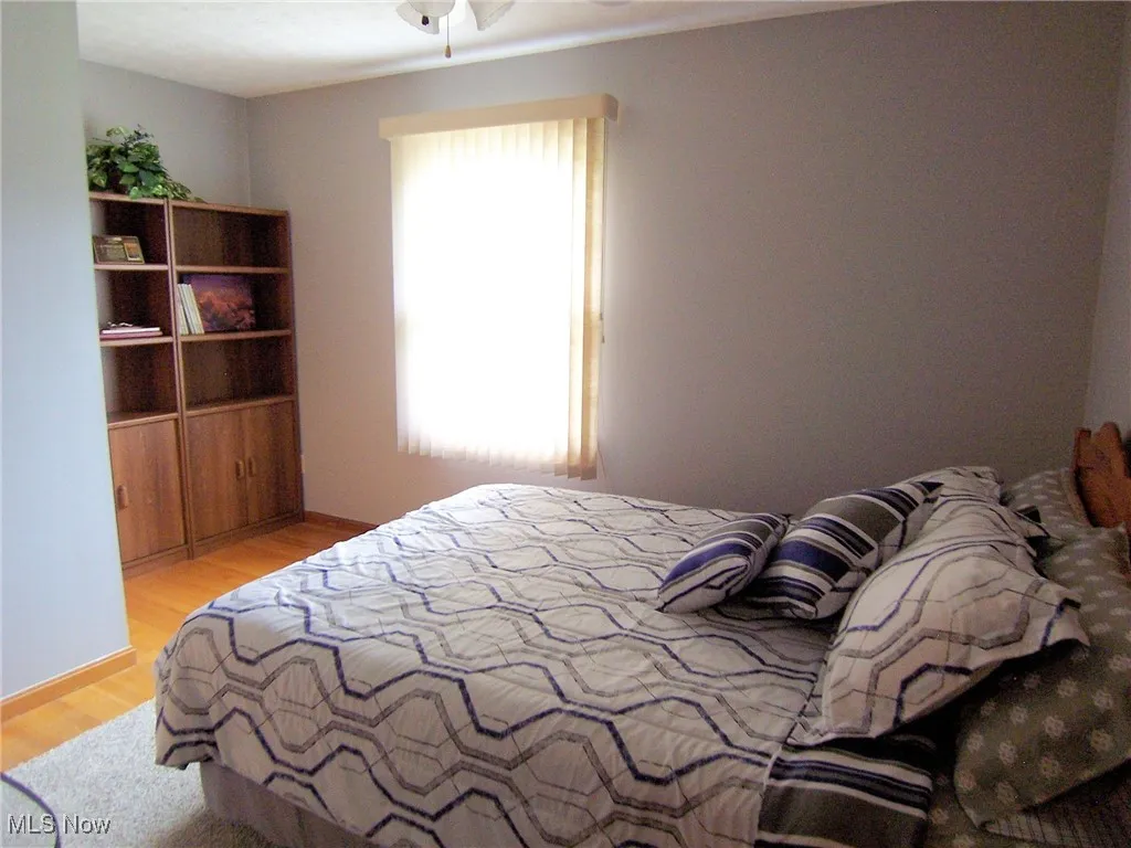 Bedroom featuring light wood-style floors and baseboards