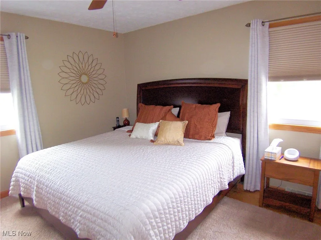 Bedroom featuring ceiling fan and carpet
