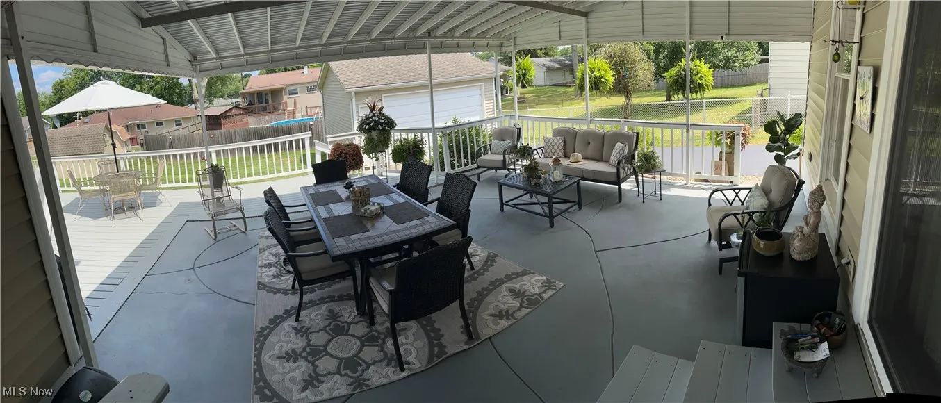 View of patio / terrace with a wooden deck, outdoor dining area, a residential view, and an outdoor living space