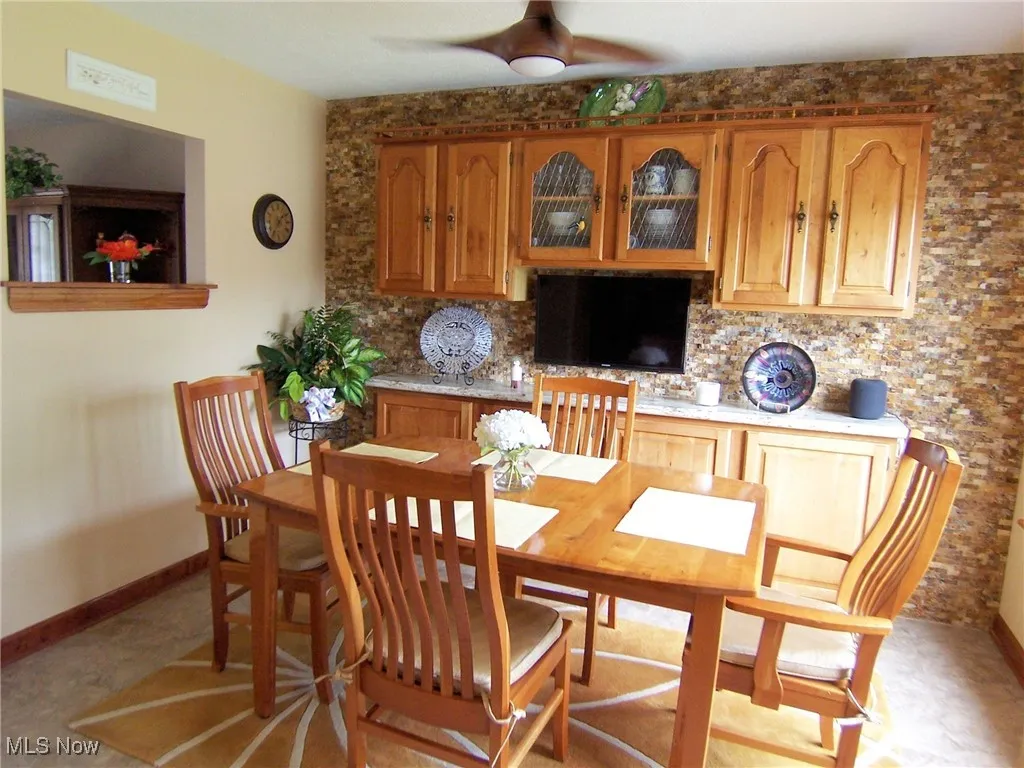 Dining space with baseboards and a ceiling fan