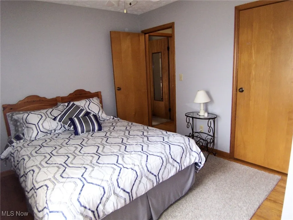 Bedroom with baseboards and wood finished floors