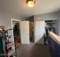 Bedroom featuring dark carpet