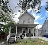 Rear view of house featuring covered porch