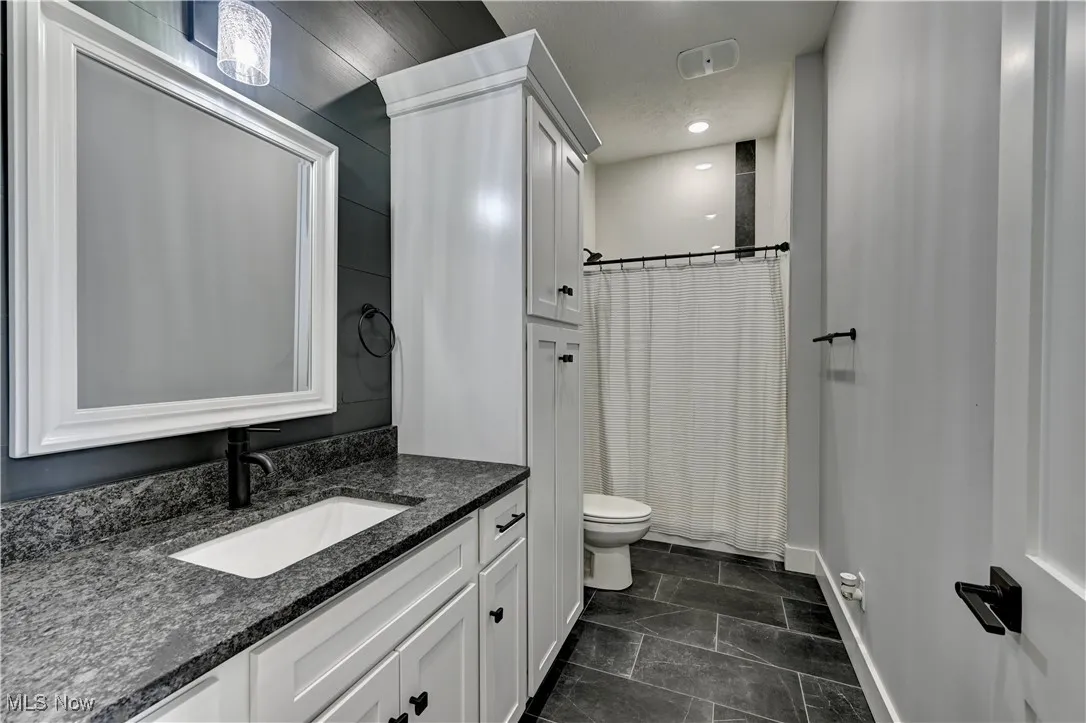 Main floor Bathroom with vanity and a shower with shower curtain