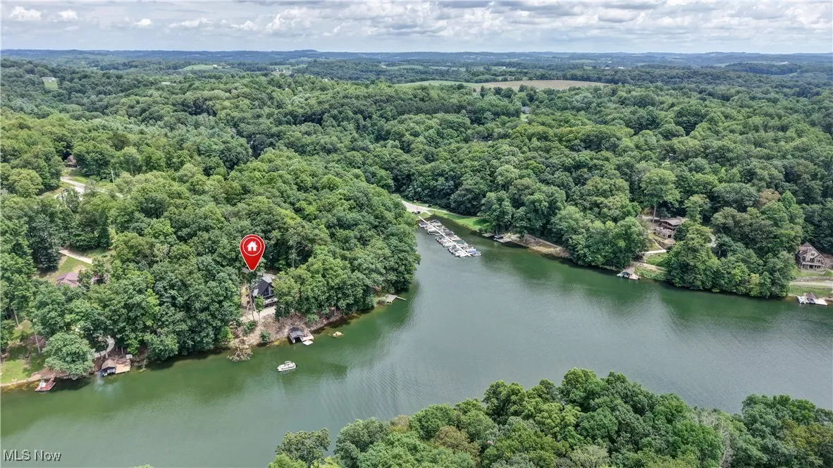 View of property location featuring a heavily wooded area and a large body of water