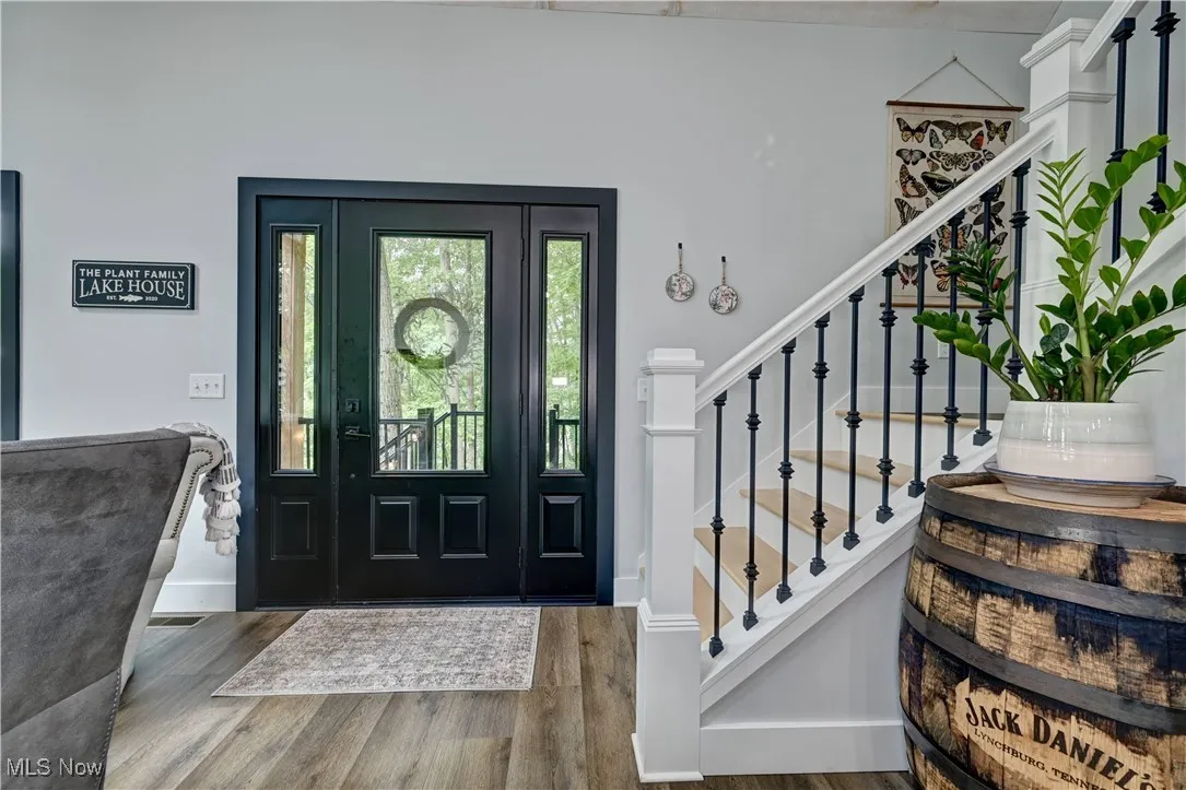 Entrance foyer with stairs and wood finished floors
