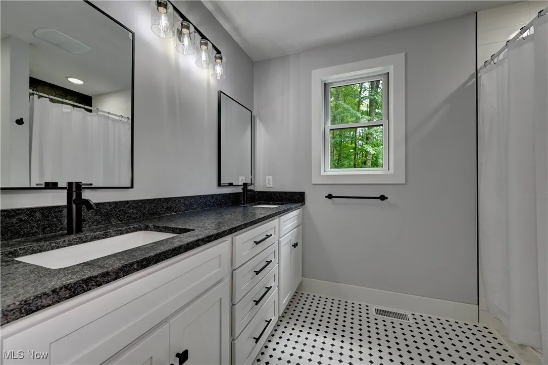 Master Bathroom with double vanity and curtained shower
